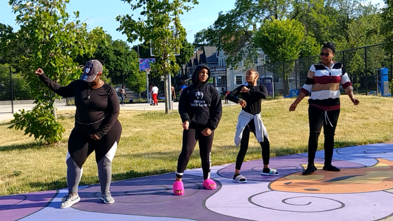 Four Amani resident's dance in Moody Park at one of the exercise programs